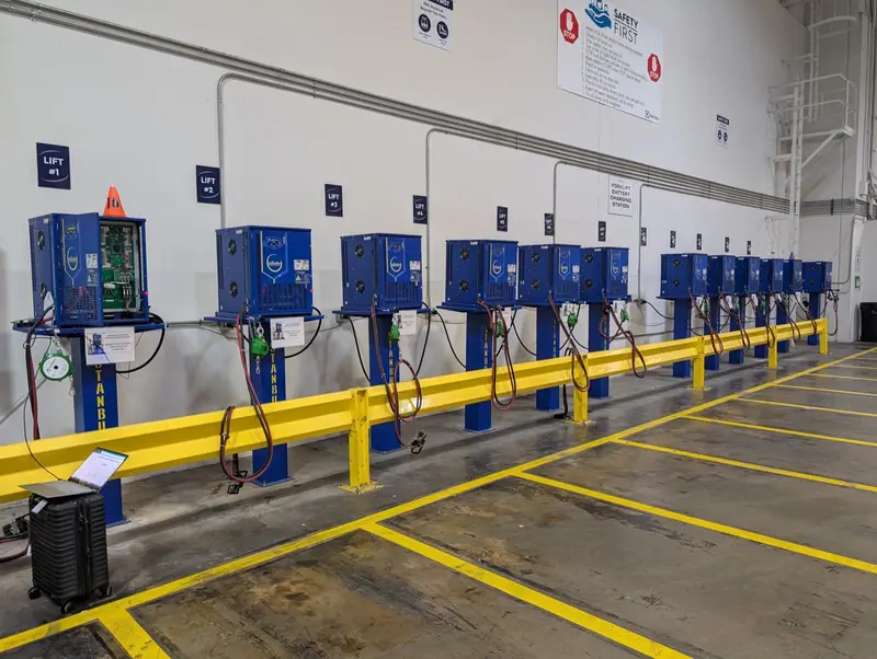 Row of Stanbury chargers on stands behind a yellow barrier
