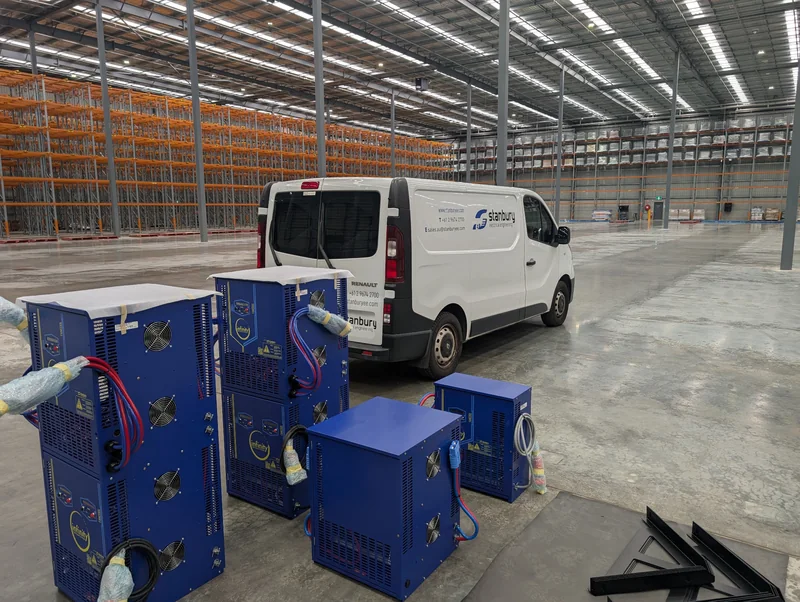 Stanbury service van beside industrial battery chargers in a warehouse